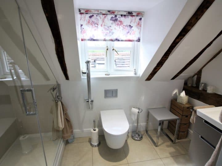A stylish bathroom in the eaves of a Tudor cottage