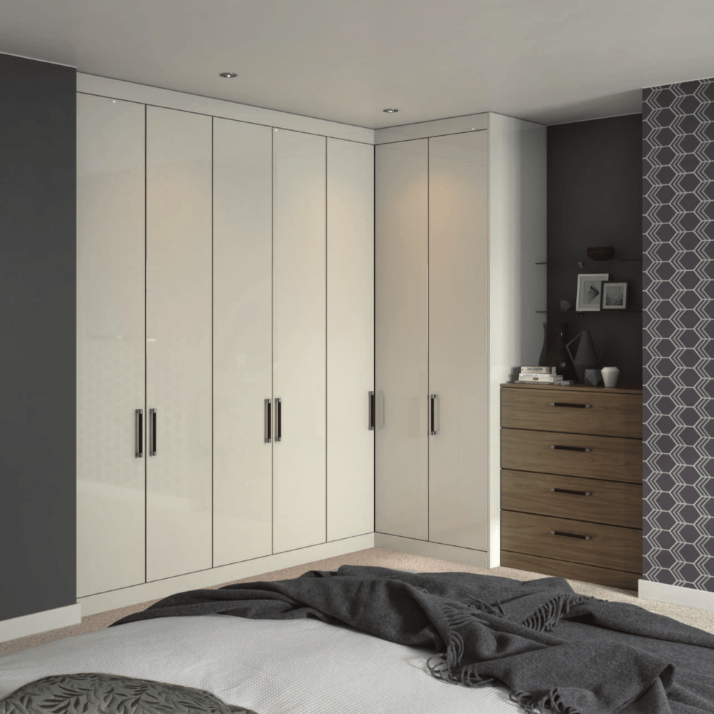 A bedroom with white cabinets and a bed