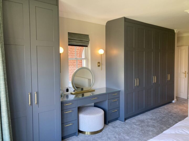 An elegant pipe grey bedroom with cloudy oak and bespoke storage solutions